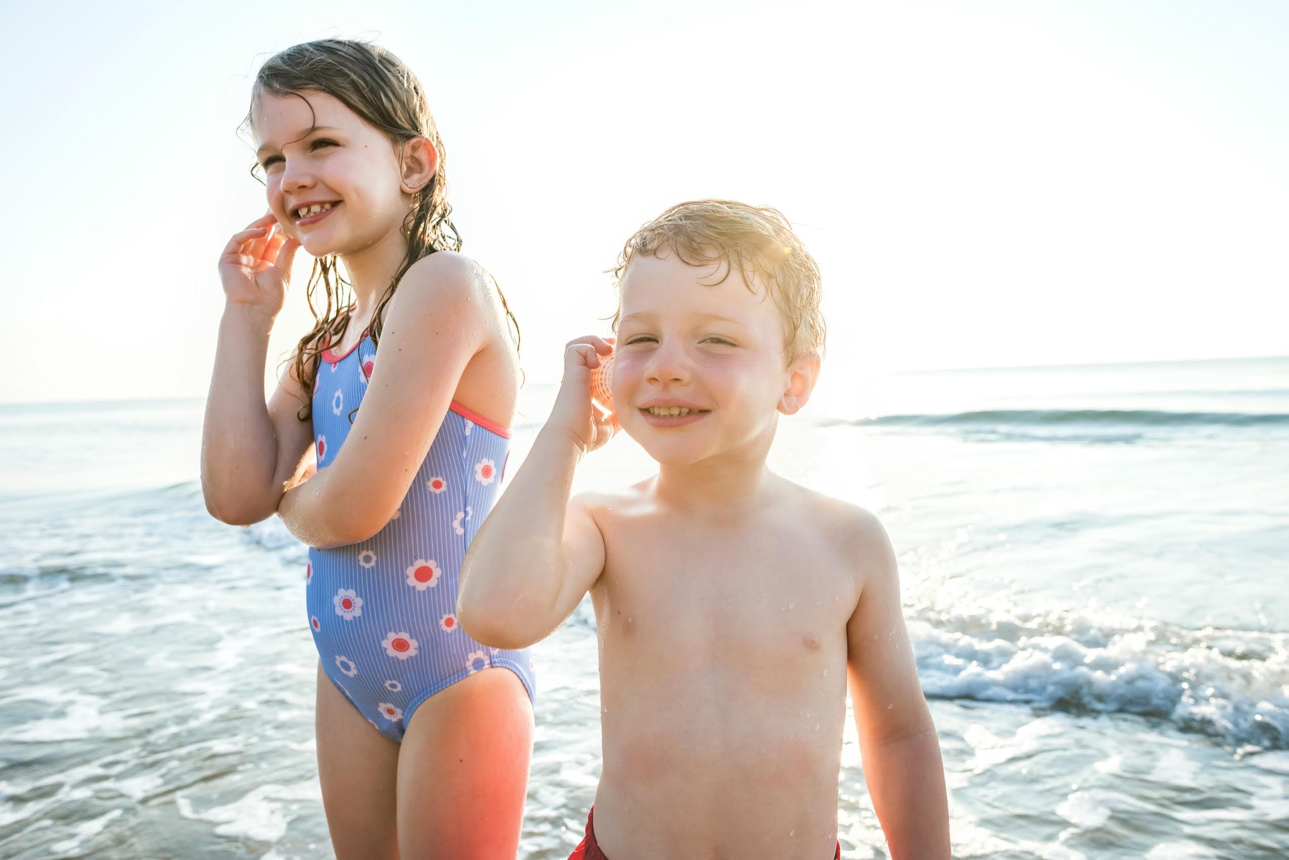 Two children playing together at the beach